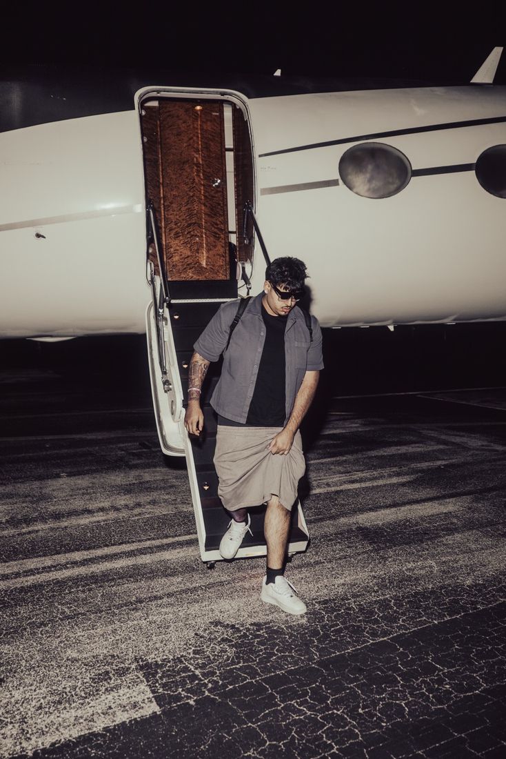 Harman 2x stepping off a private jet